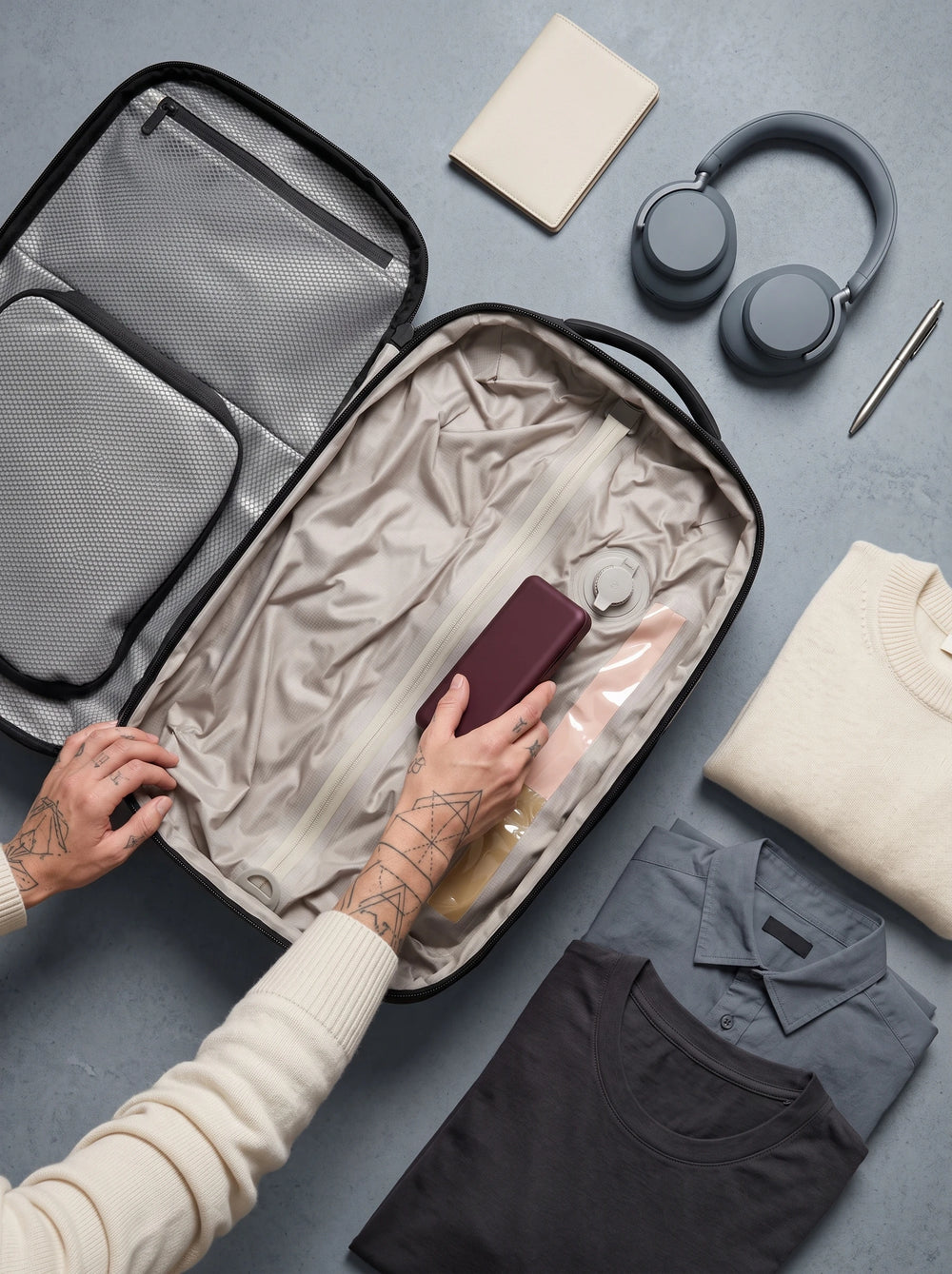 Hands organizing clothes and accessories inside Lavnex ZoraPack Pro™ travel backpack showing compression system and internal compartments