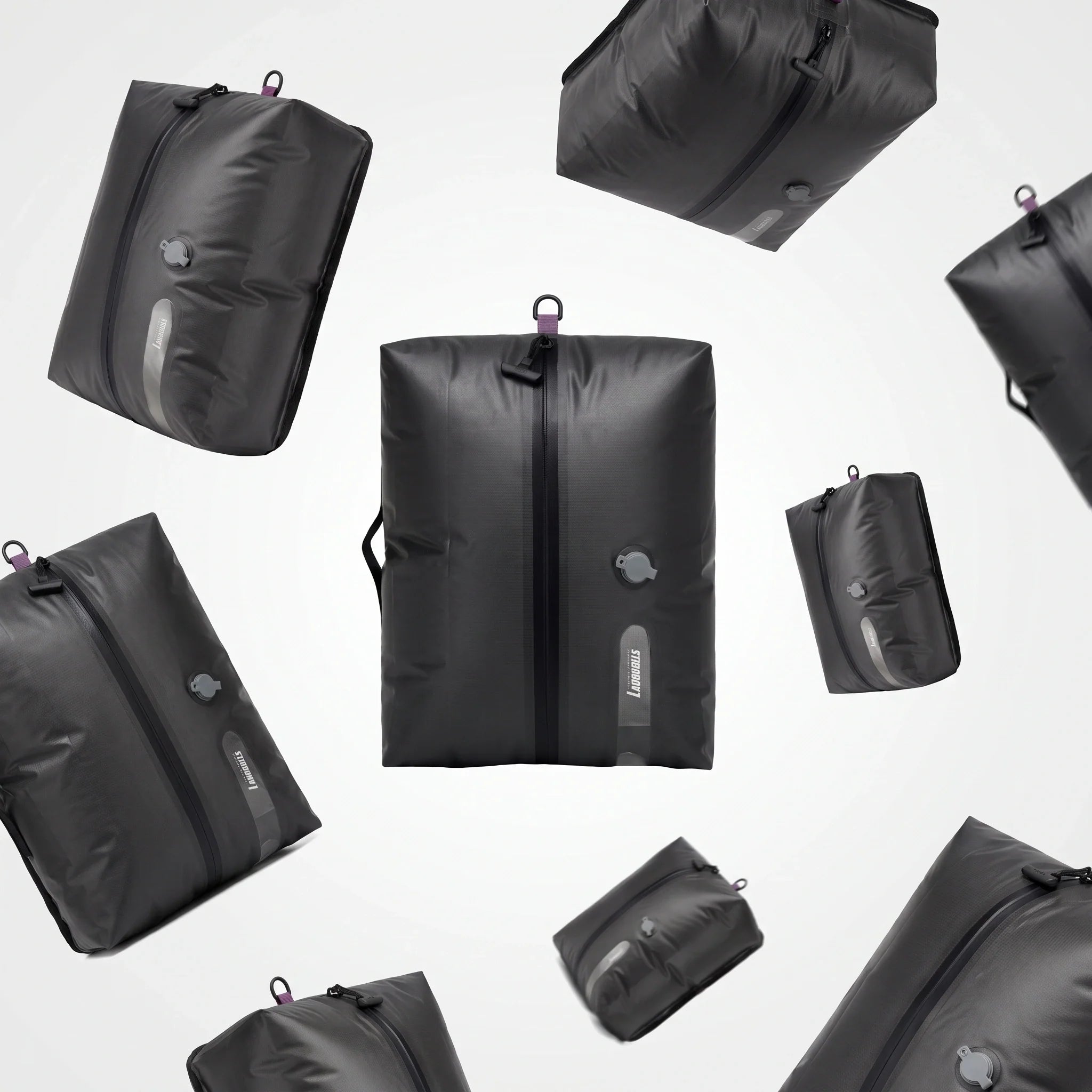 Floating display of Lavnex AirPack Vacuum Bag™ compression travel bags in matte black with air valve and zipper design