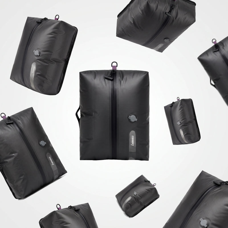 Floating display of Lavnex AirPack Vacuum Bag™ compression travel bags in matte black with air valve and zipper design