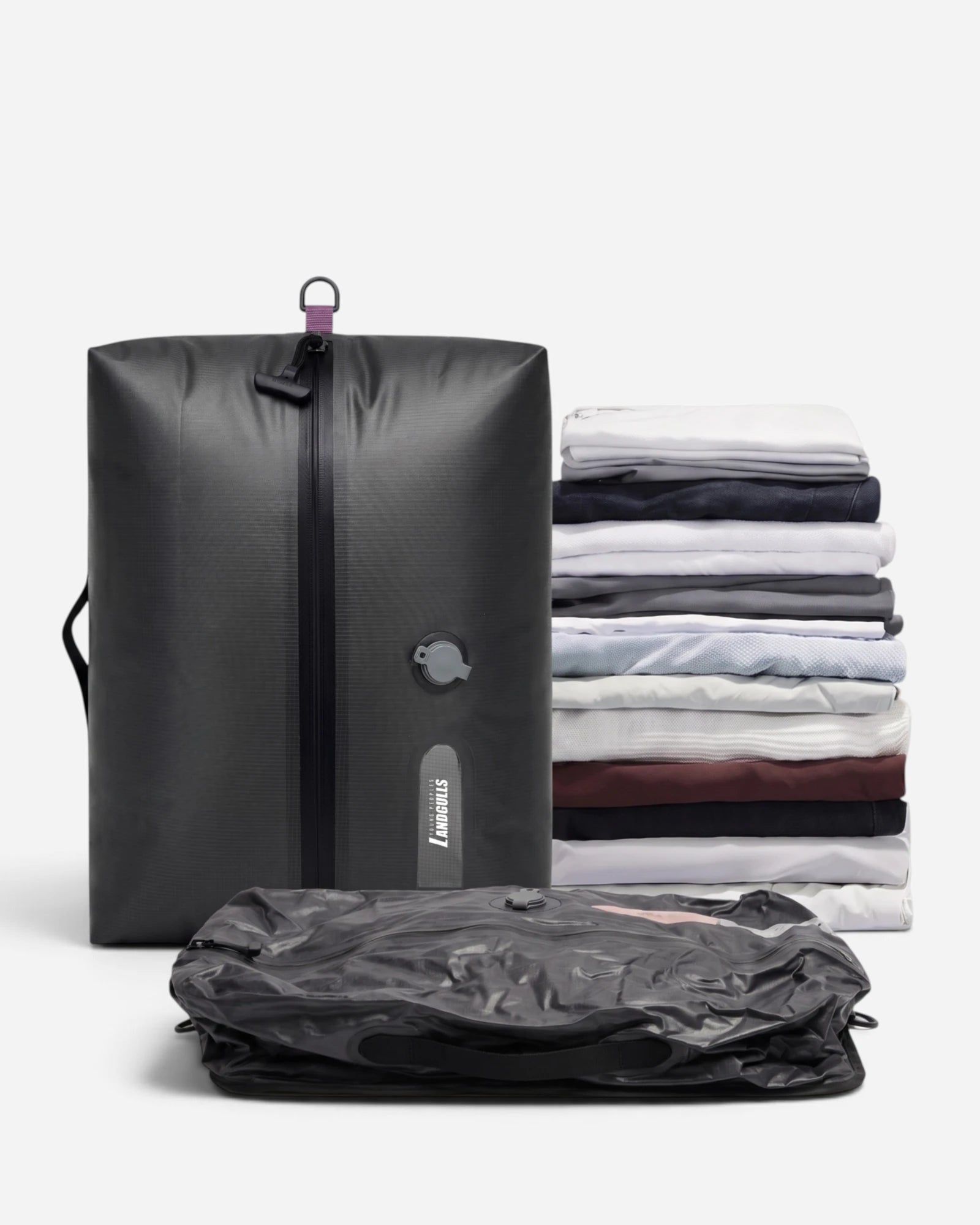 Lavnex Rilvac™ Jet Black vacuum compression bag shown upright next to flattened version and stack of folded clothes demonstrating space reduction
