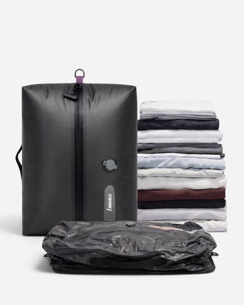 Lavnex Rilvac™ Jet Black vacuum compression bag shown upright next to flattened version and stack of folded clothes demonstrating space reduction