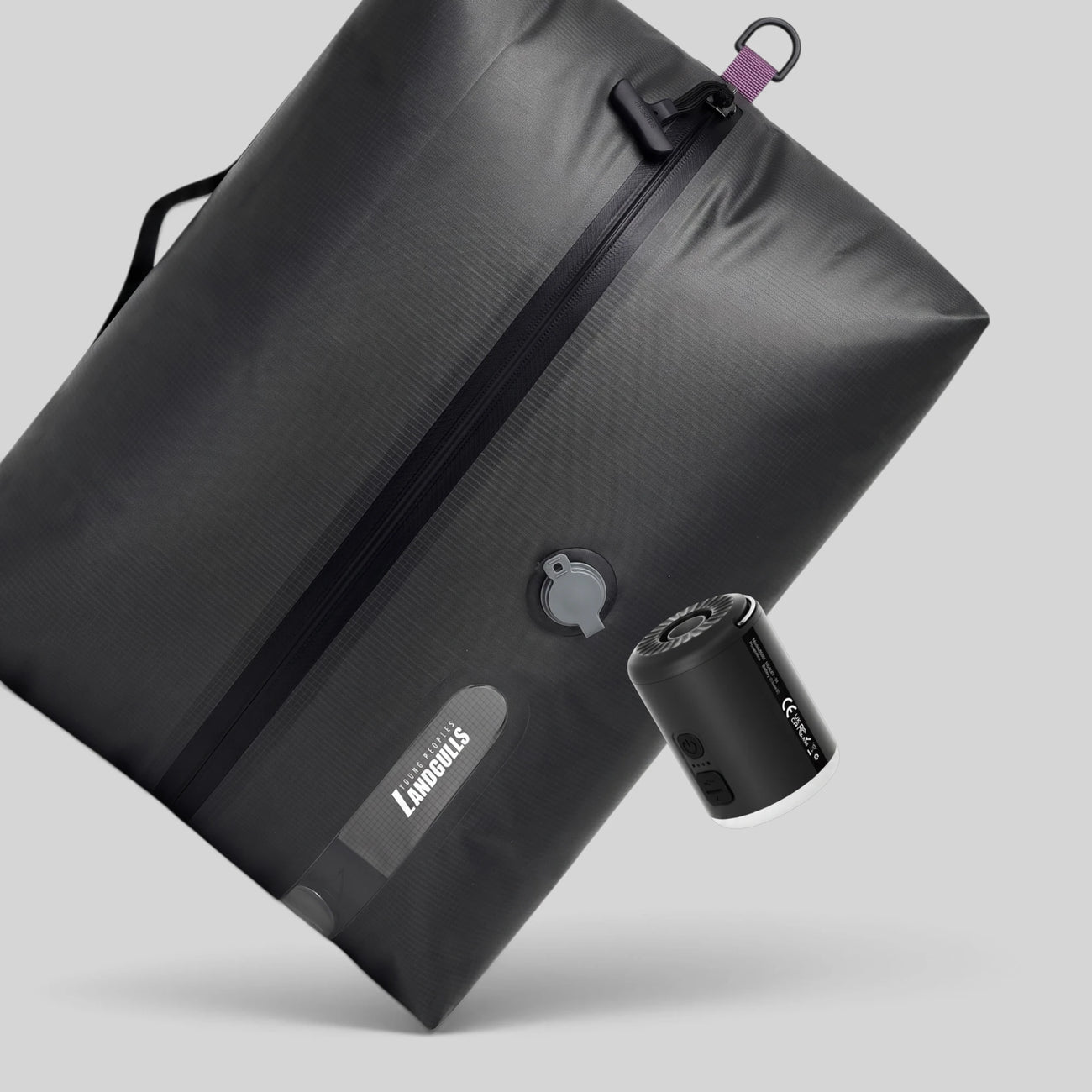 Lavnex Rilvac™ Jet Black vacuum compression bag angled with VoxAir Pro™ portable air pump showing sleek design and smart compression technology
