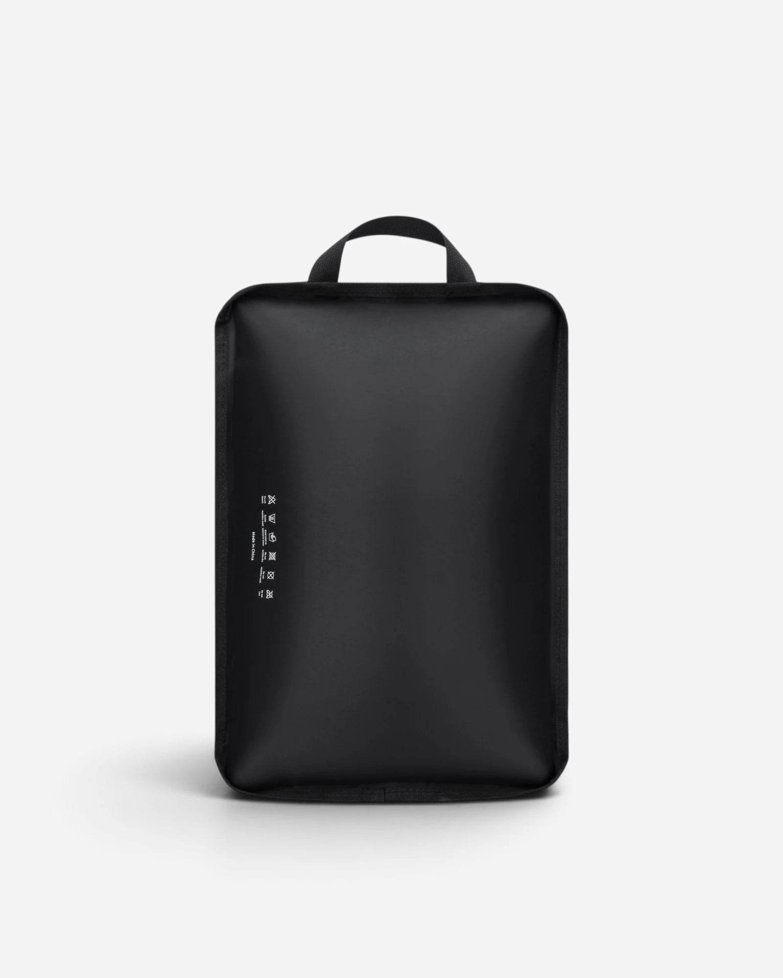 Back view of Lavnex Still Vac™ Jet Black vacuum compression bag showing top handle and minimalist design with printed icons and text