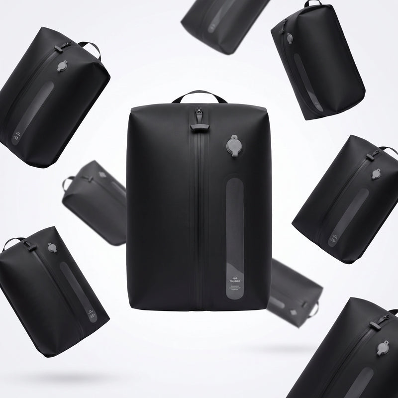Multiple Lavnex Still Vac™ Jet Black vacuum compression bags floating against light gray background showing sleek design and modern aesthetic