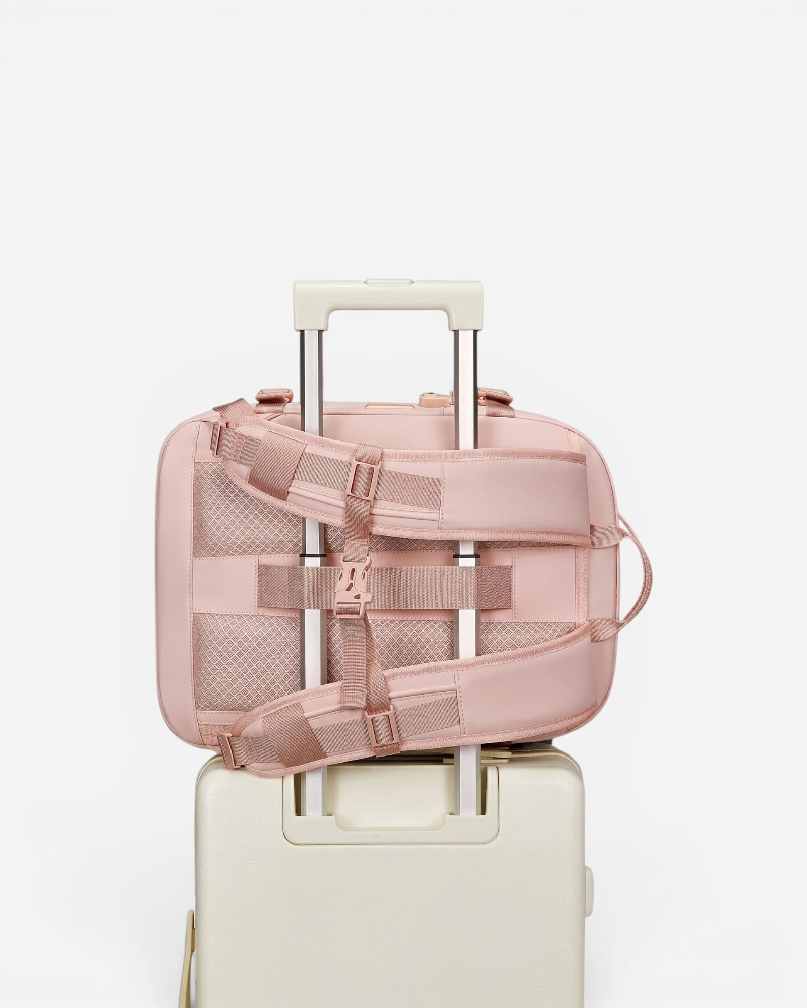 Lavnex ZoraPack Mini™ Rose Blush backpack attached to cream suitcase handle showing travel‑friendly design