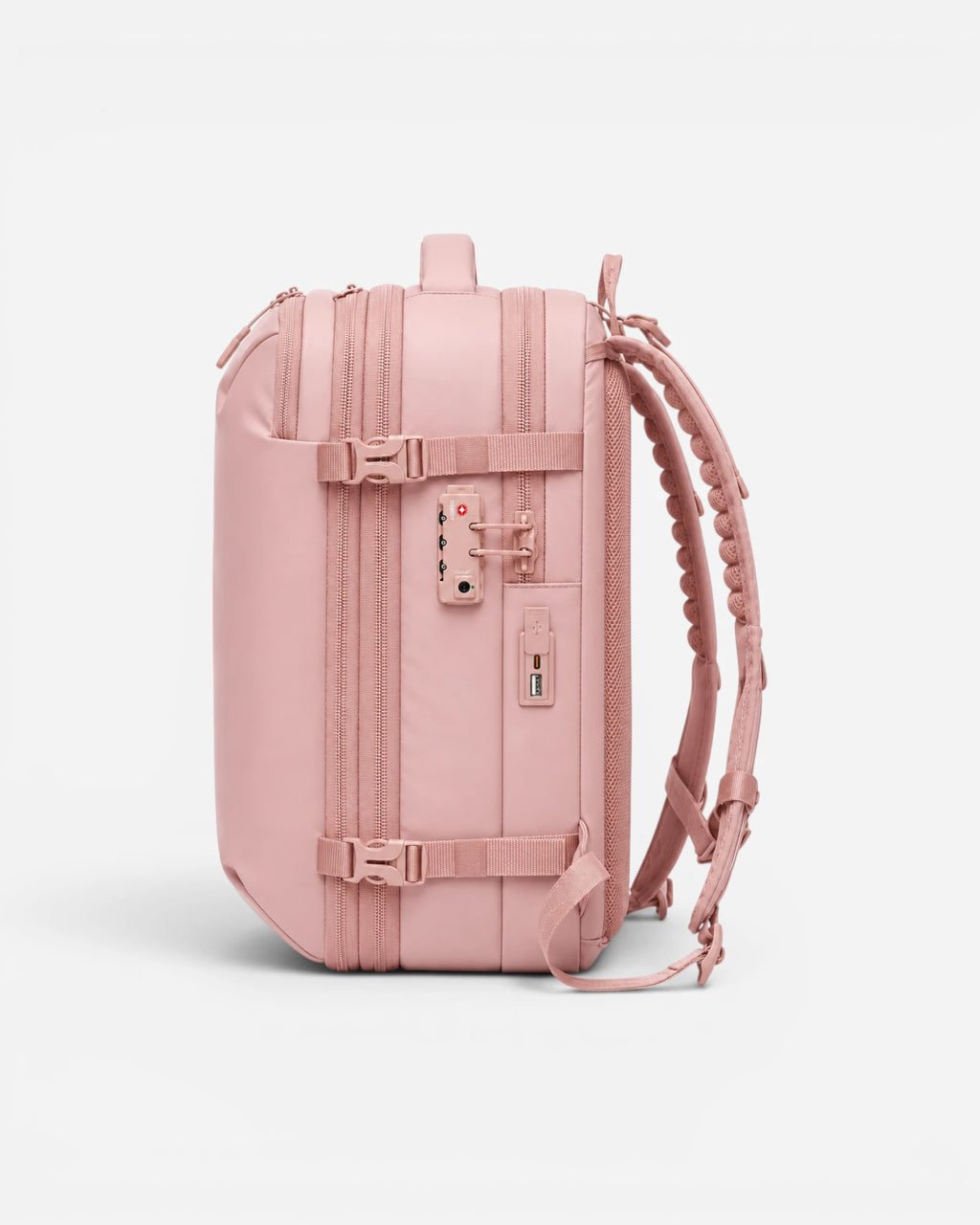 Side view of Lavnex ZoraPack Pro™ Rose Blush backpack showing TSA lock, USB charging port, and compression straps in soft pink finish