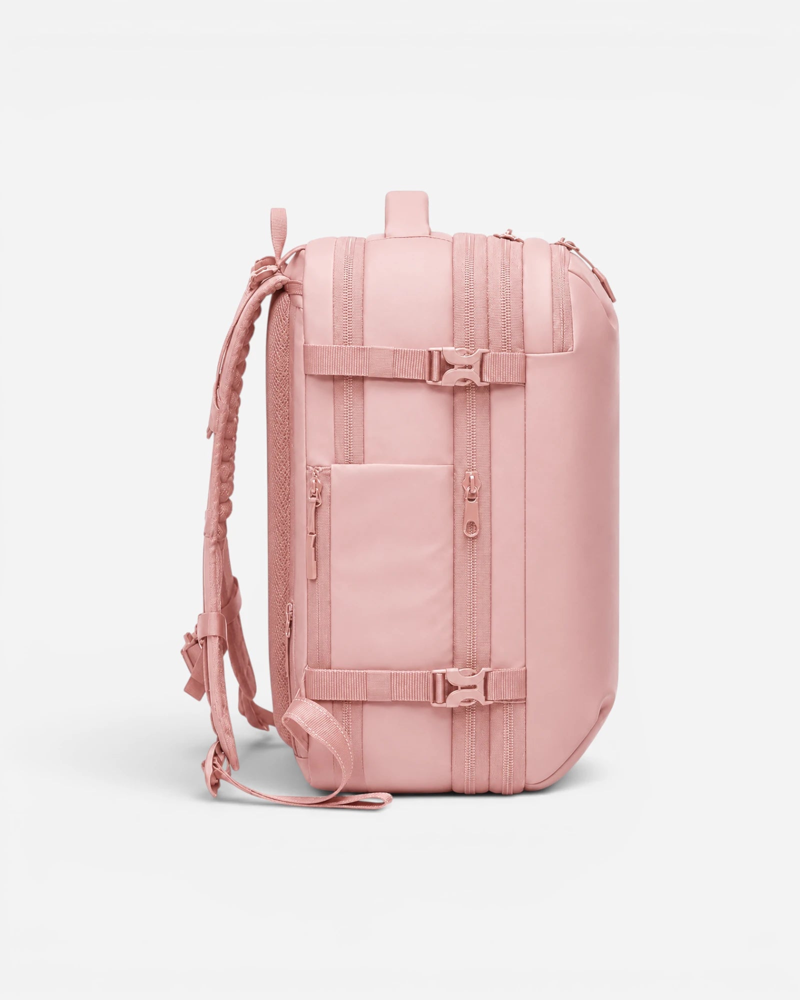 Side view of Lavnex ZoraPack Pro™ Rose Blush backpack showing waterproof zippers, compression straps, and side pocket design in soft pink finish