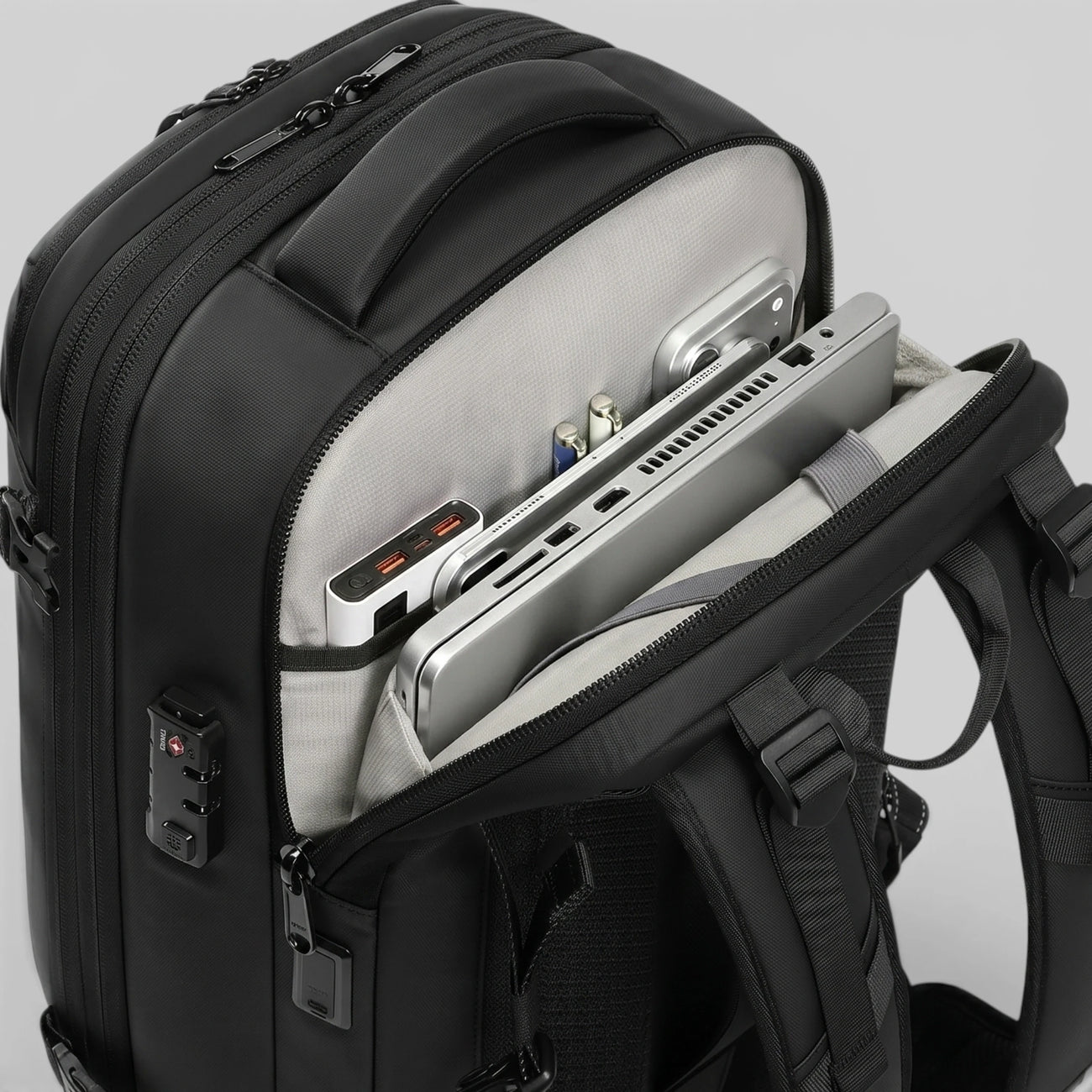 Close‑up of Lavnex ZoraPack Pro backpack showing organized laptop, tablet, and accessories in padded compartments