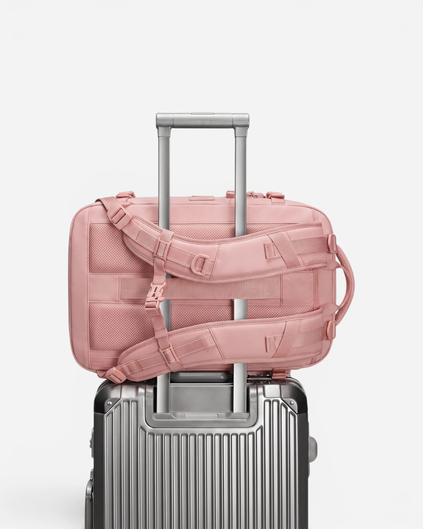 Lavnex ZoraPack Pro backpack attached to silver suitcase handle for easy travel