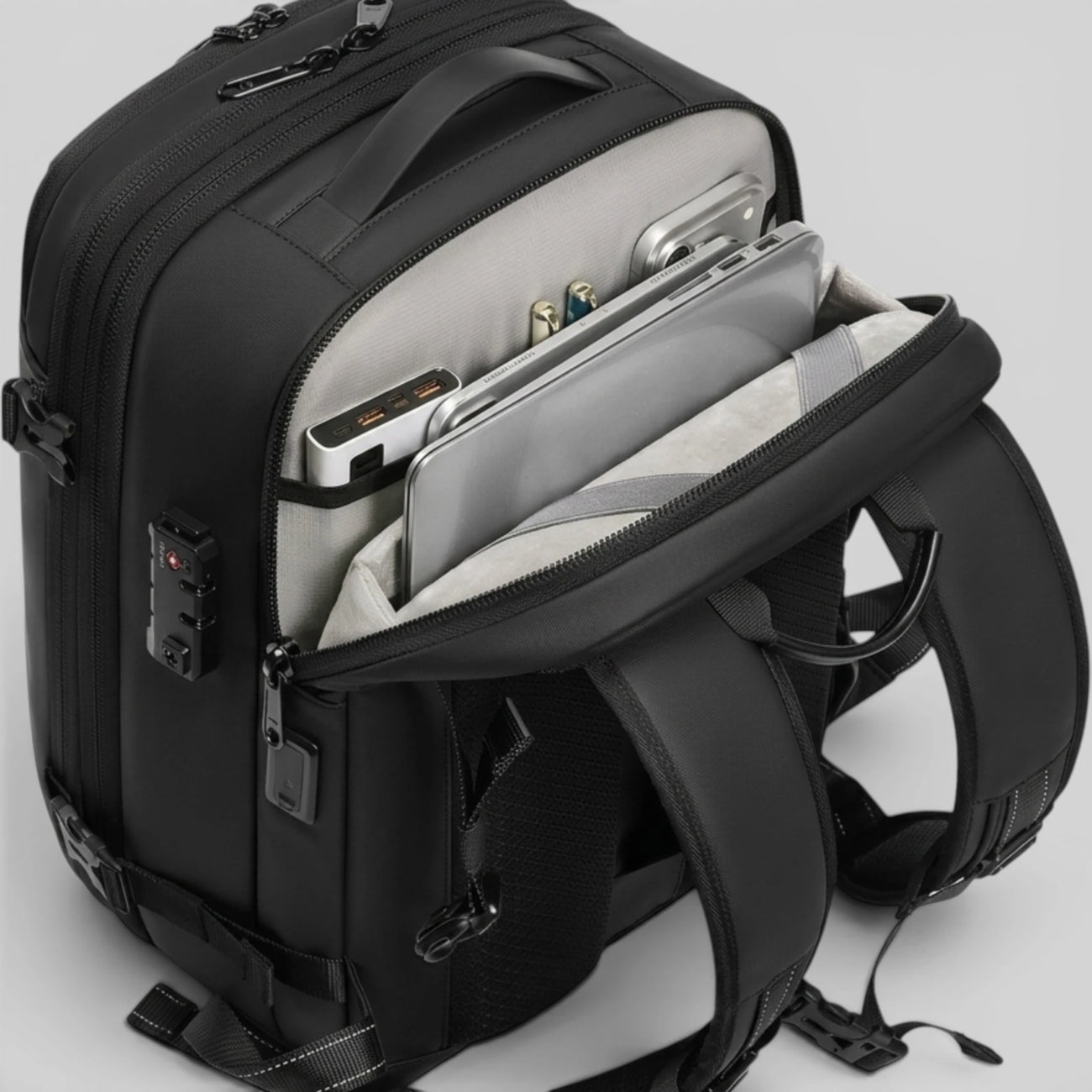 Close‑up of Lavnex ZoraPack mini backpack showing organized laptop, tablet, and accessories in padded compartments